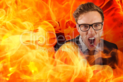 Composite image of young angry businessman shouting at camera