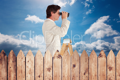 Composite image of businessman looking on a ladder