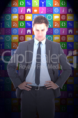 Composite image of serious businessman with hands on hips