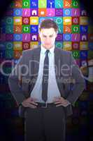 Composite image of serious businessman with hands on hips