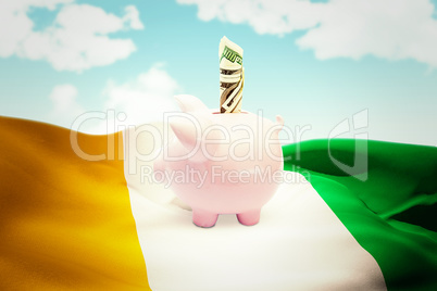 Composite image of dollar in piggy bank