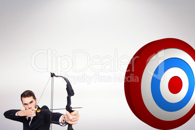 Composite image of smart businessman practicing archery looking