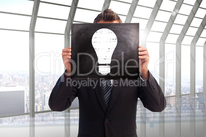 Composite image of businessman showing board