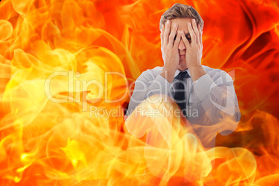 Composite image of businessman with a headache