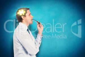 Composite image of thinking businessman biting glasses