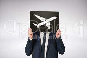 Composite image of businessman holding board