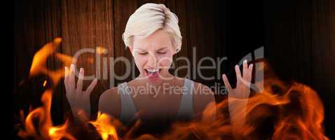 Composite image of angry blonde yelling with hands up