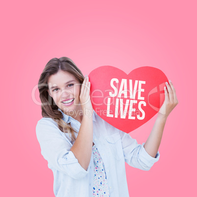 Composite image of woman holding heart card