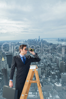 Composite image of businessman looking on a ladder