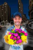 Composite image of happy delivery man holding bouquet