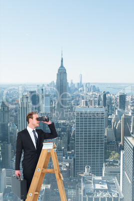 Composite image of businessman looking on a ladder