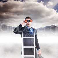 Composite image of businessman looking on a ladder