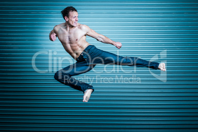 Man in jeans performing a kick. Martial arts
