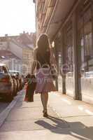 Urban girl striding through a city street