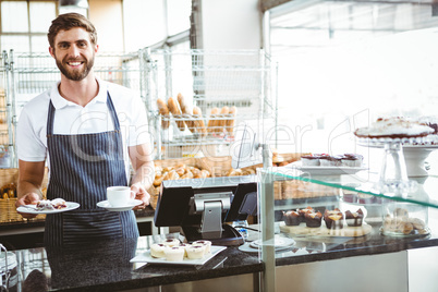 Smiling worker prepares breakfast