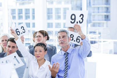 Smiling business team showing paper with rating