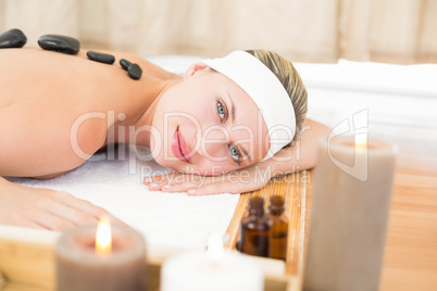 Beautiful blonde enjoying a hot stone massage