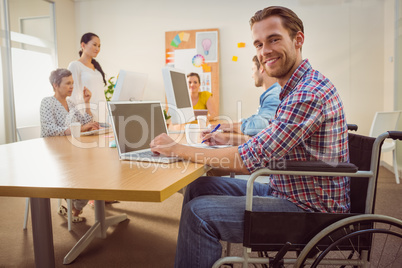 Creative casual businessman in wheelchair