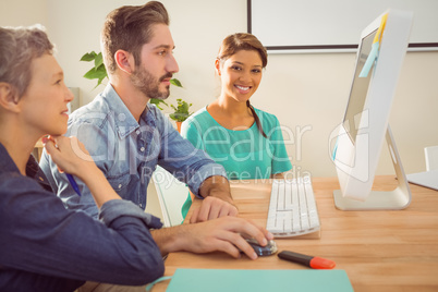 Colleagues using laptop at office