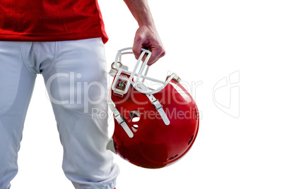 An american football player taking his helmet on hand