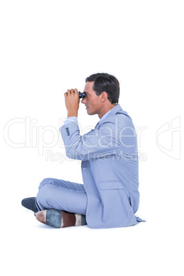 Businessman looking through binoculars