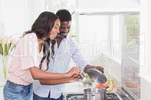 Happy couple cooking food together