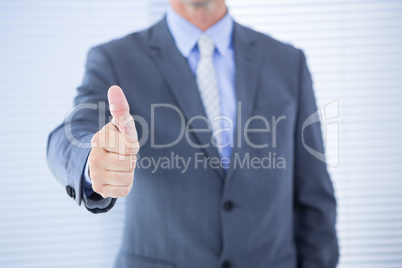 positive businessman smiling with thumb up