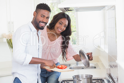 Happy couple cooking food together