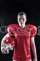 A serious american football player looking at camera