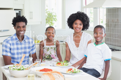 Happy family sitting down to dinner together