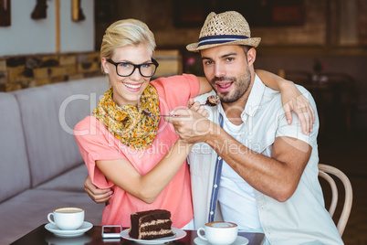 Cute couple on a date giving each other food