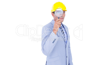 businessman with helmet and magnifier