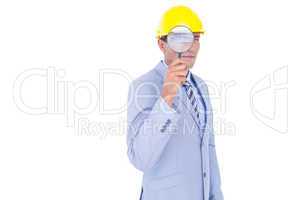 businessman with helmet and magnifier