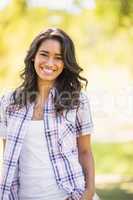 Pretty brunette looking at camera in the park