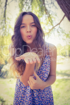 Pretty brunette blowing kiss at camera