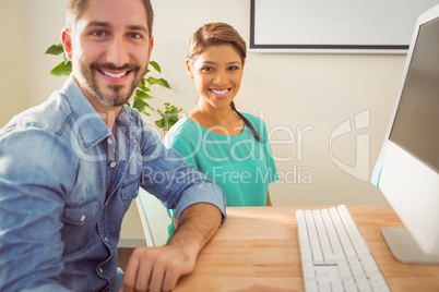 Portrait of two colleague using a computer