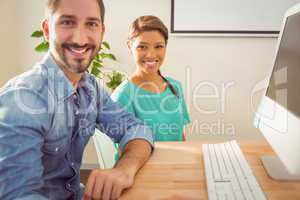 Portrait of two colleague using a computer