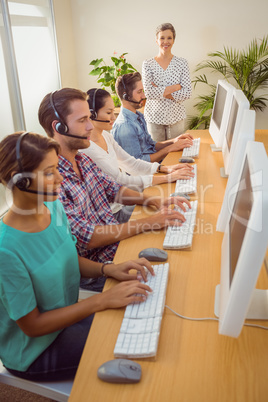 Manager supervising work in call center