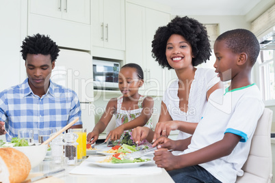 Happy family sitting down to dinner together