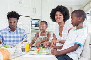 Happy family sitting down to dinner together