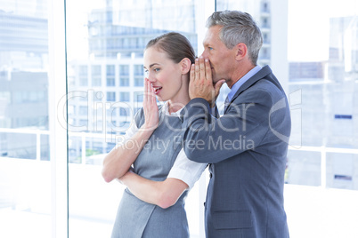 Secretive business colleagues whispering