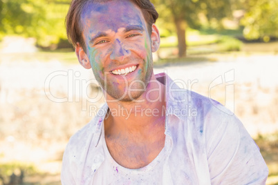 Young man having fun with powder paint