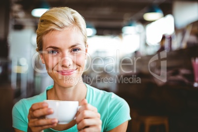 Pretty blonde holding cup of coffee