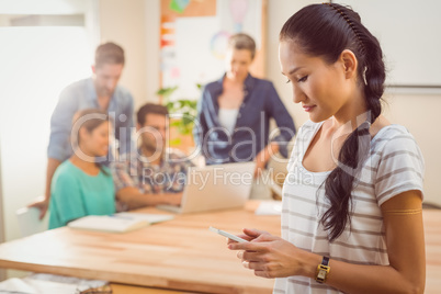 Businesswoman using her phone in the office