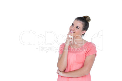 Thoughtful pretty casual brunette standing with hand on chin