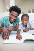 Father and son reading on the floor