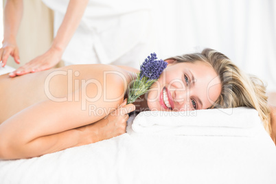 Beautiful blonde lying on massage table with lavanda