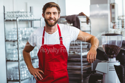 Handsome barista smiling at the camera