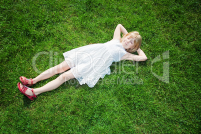 young girl lying on grass