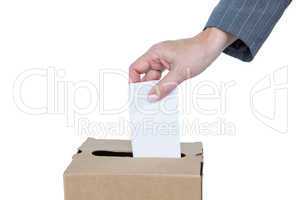 Businessman putting ballot in vote box